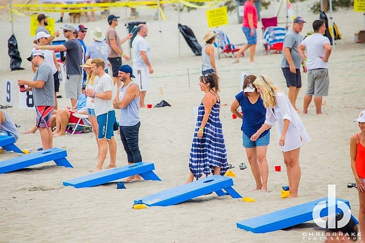 Cornhole competition on the beach at Sola Summit